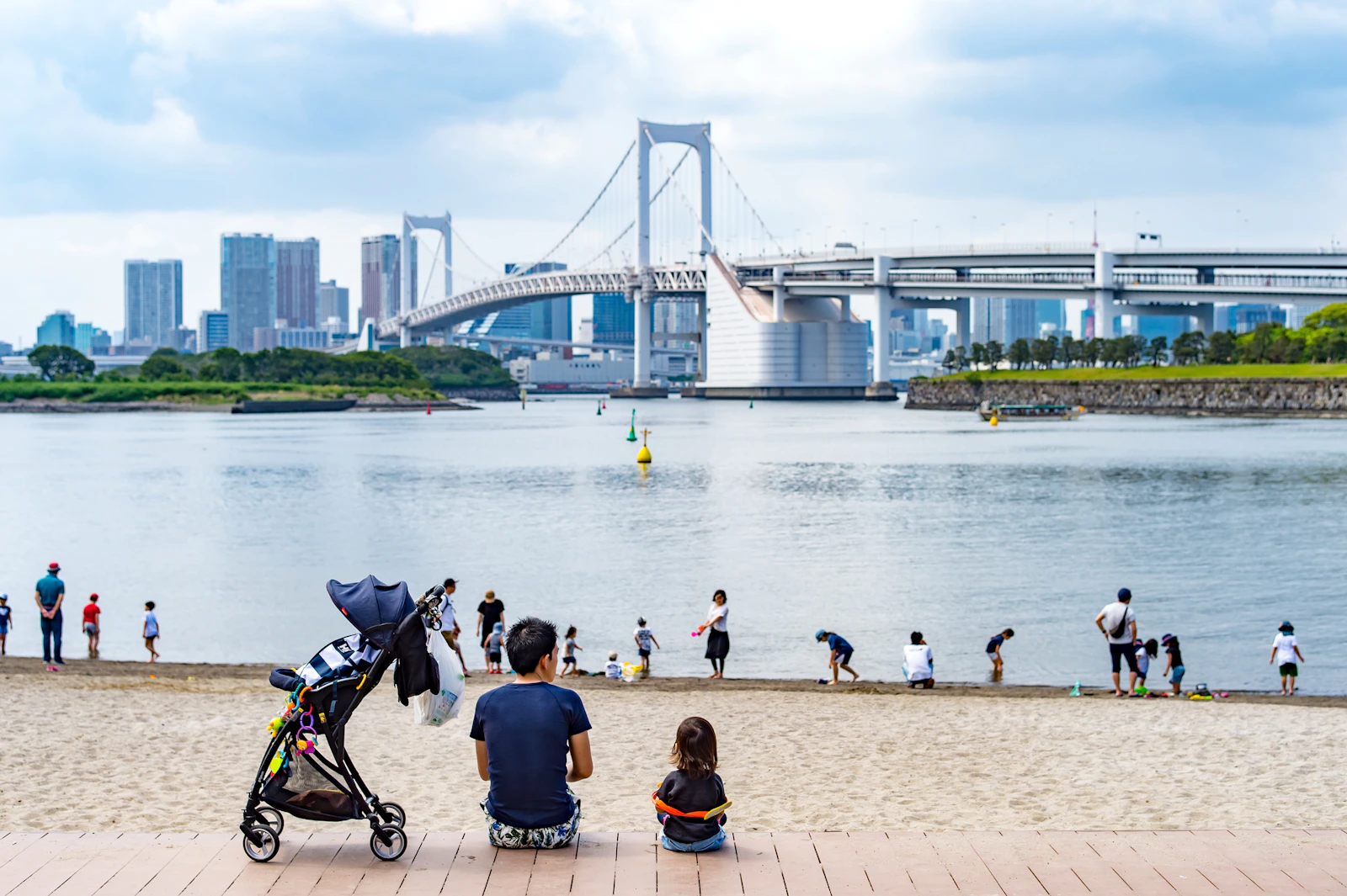 お台場海浜公園でレインボーブリッジを眺める親子